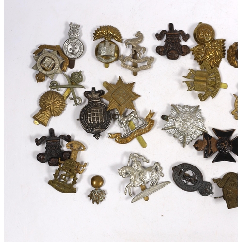 325 - Thirty military cap badges including Royal Warwickshire, Hampshire Yeomanry Carabiniers, Inniskillin... 