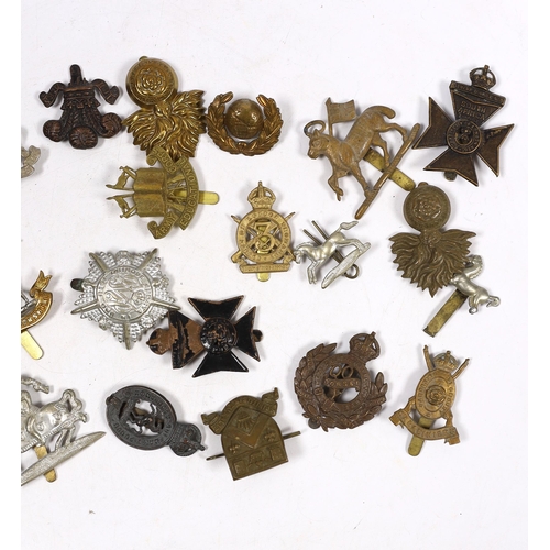 325 - Thirty military cap badges including Royal Warwickshire, Hampshire Yeomanry Carabiniers, Inniskillin... 