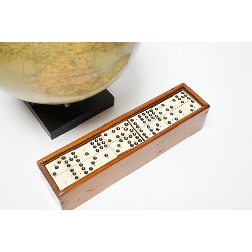 356 - A Philips 10" Challenge globe on stand and a cased set of dominoes, globe 32cm high