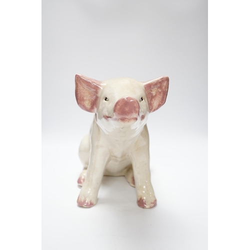 358 - A large earthenware model of a seated piglet, 31cm high