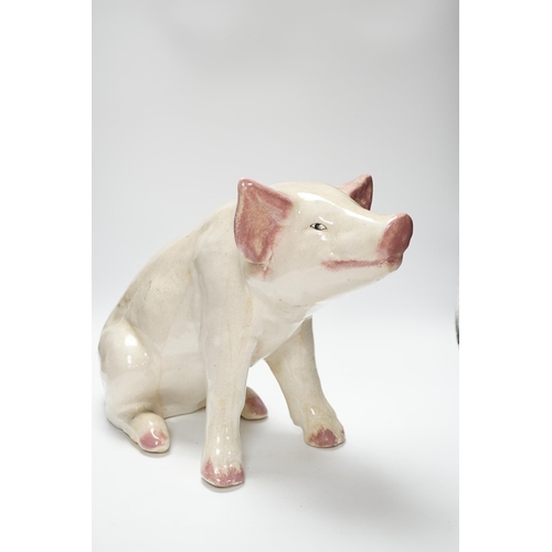 358 - A large earthenware model of a seated piglet, 31cm high