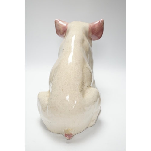 358 - A large earthenware model of a seated piglet, 31cm high