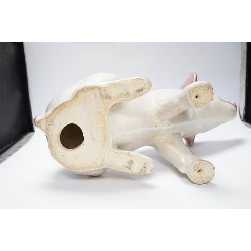 358 - A large earthenware model of a seated piglet, 31cm high