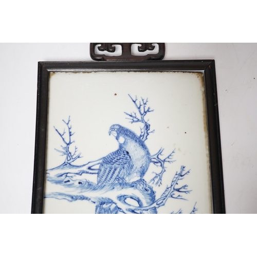 373 - A late 19th century Chinese blue and white plaque of a bird, ebonised frame, 19cm wide x 30cm high i... 