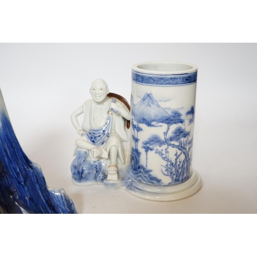 403 - An early 19th century Japanese Hirado blue and white model of a monk seated by Mount Fuji, and a sim... 