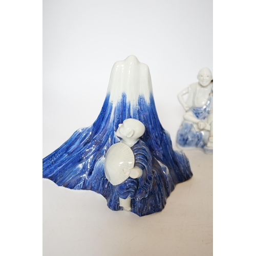 403 - An early 19th century Japanese Hirado blue and white model of a monk seated by Mount Fuji, and a sim... 