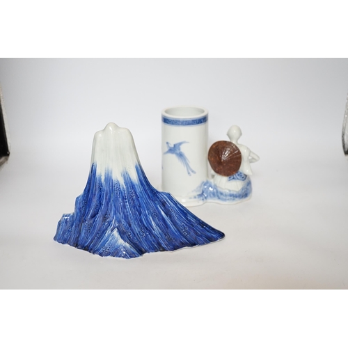 403 - An early 19th century Japanese Hirado blue and white model of a monk seated by Mount Fuji, and a sim... 