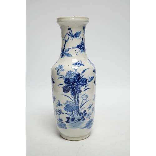 411 - A 19th century Chinese blue and white vase decorated with flowers and bugs, 25cm high