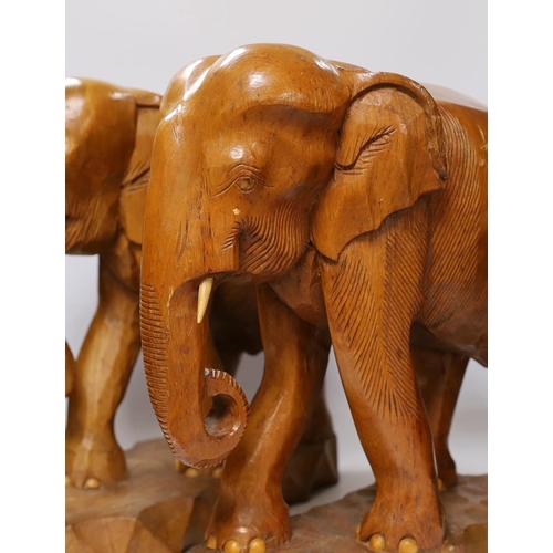 421 - A pair of carved teak elephants, 42cm high