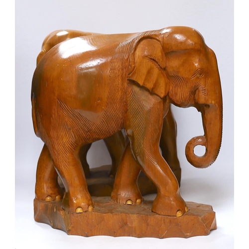 421 - A pair of carved teak elephants, 42cm high