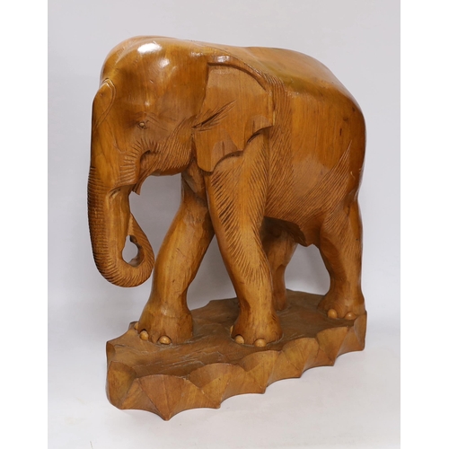 421 - A pair of carved teak elephants, 42cm high