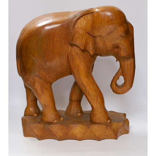 421 - A pair of carved teak elephants, 42cm high