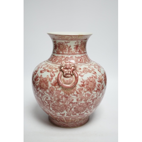 422 - A Chinese underglaze copper red floral vase with twin handles, 27cm high