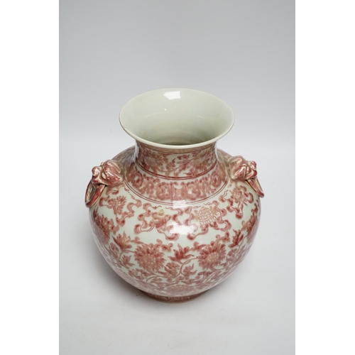 422 - A Chinese underglaze copper red floral vase with twin handles, 27cm high