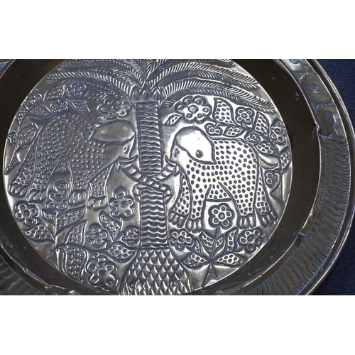 441 - An embossed brass table top/ tray, 74cm diameter