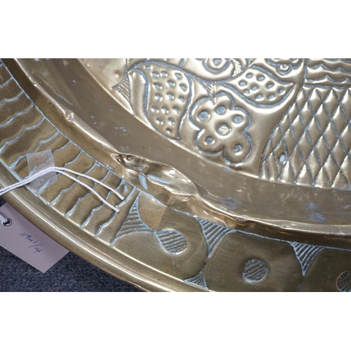 441 - An embossed brass table top/ tray, 74cm diameter