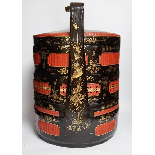 454 - A Chinese three section lacquer wedding basket with gilded decoration