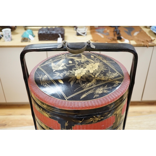 454 - A Chinese three section lacquer wedding basket with gilded decoration