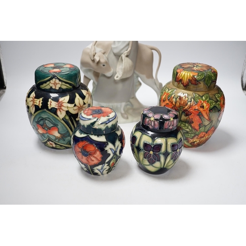 459 - Four modern Moorcroft jars and covers, largest 16cm high, three boxed and a Nao figure group, talles... 