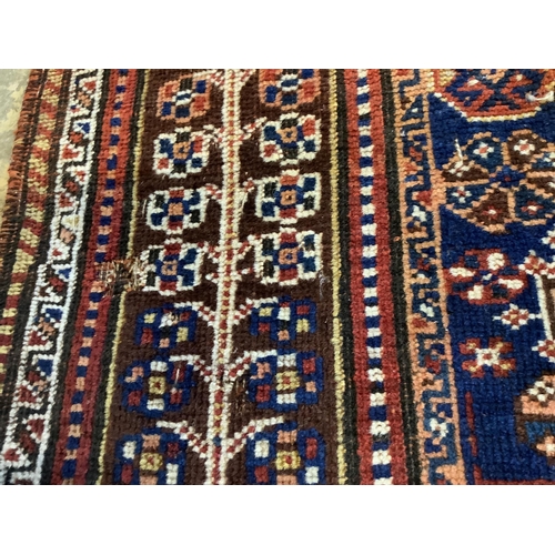 47 - An antique Qashqai red ground rug, 260 x 174cm