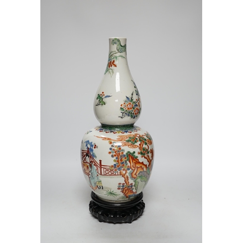 473 - A Chinese enamelled porcelain double-gourd vase on hardwood stand, 41cm total height