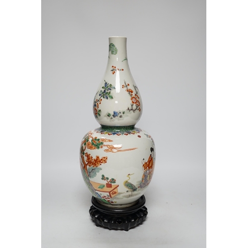 473 - A Chinese enamelled porcelain double-gourd vase on hardwood stand, 41cm total height