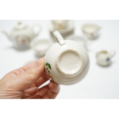 487 - A childs tea set comprising a teapot, five cups and saucers and a milk jug, teapot 8.5cm