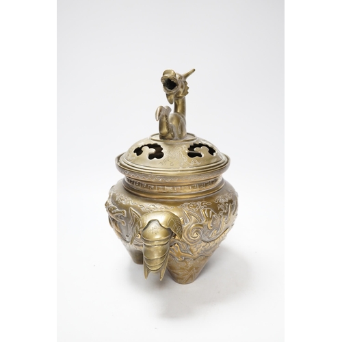 511 - A Chinese bronze dragon tripod censer and cover, 24cm