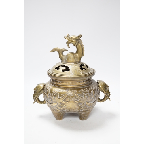 511 - A Chinese bronze dragon tripod censer and cover, 24cm