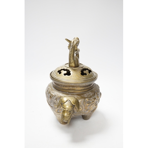 511 - A Chinese bronze dragon tripod censer and cover, 24cm