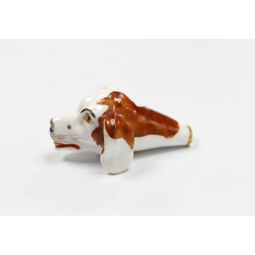 552 - An early 19th century Staffordshire porcelain dogs head whistle, 5cm