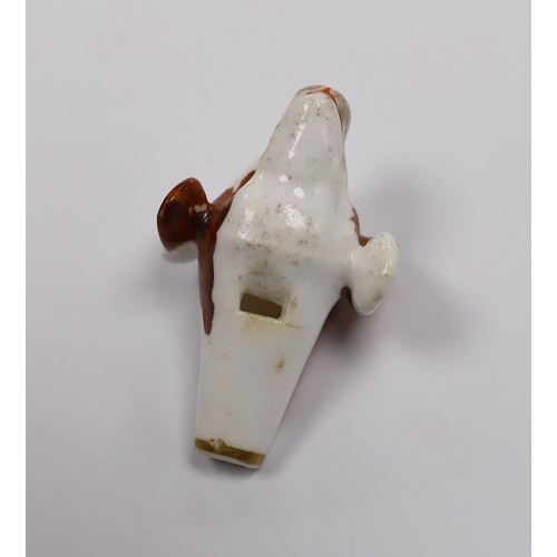 552 - An early 19th century Staffordshire porcelain dogs head whistle, 5cm