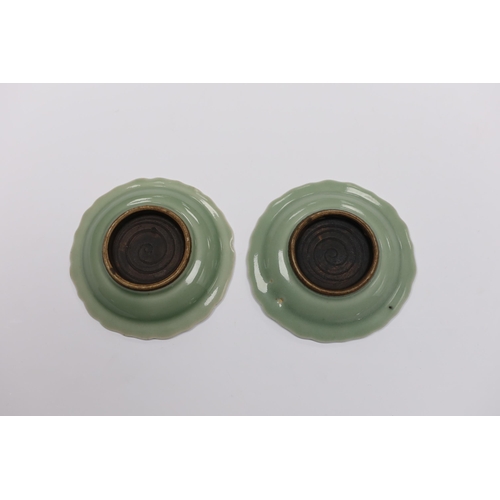 558 - A pair of Japanese celadon dishes, 11.5cm diameter