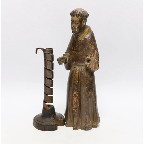 570 - An 18th century Spanish carved and painted wood figure of a monk and 18th century rat de cave cand... 