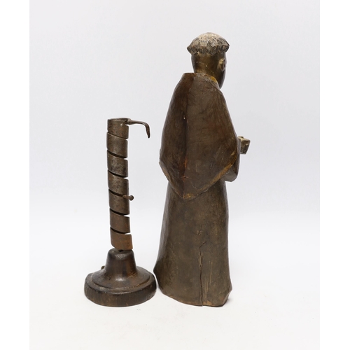 570 - An 18th century Spanish carved and painted wood figure of a monk and 18th century rat de cave cand... 