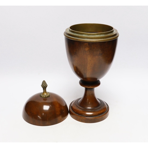 571 - A turned wood urn and cover with brass acorn finial, 37cm high