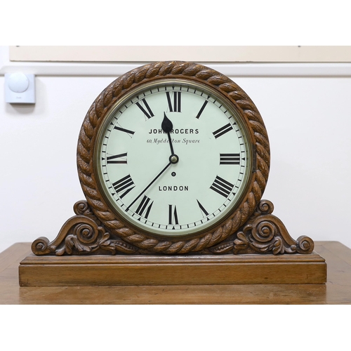 596 - A Victorian carved oak mantel timepiece with fusee movement, signed John Rogers of London, 62cm wide... 