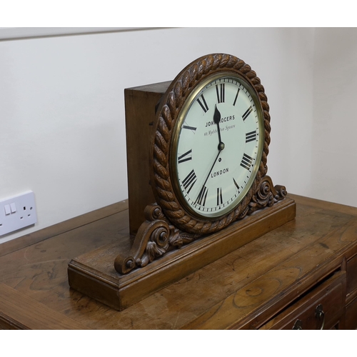 596 - A Victorian carved oak mantel timepiece with fusee movement, signed John Rogers of London, 62cm wide... 