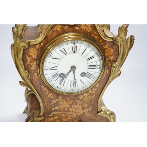 604 - A French gilt metal mounted rosewood and floral marquetry mantel clock. 40cm