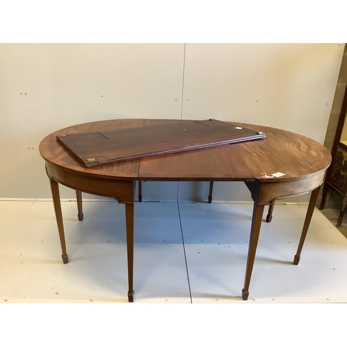 71 - A George III mahogany D-end extending dining table with two leaves