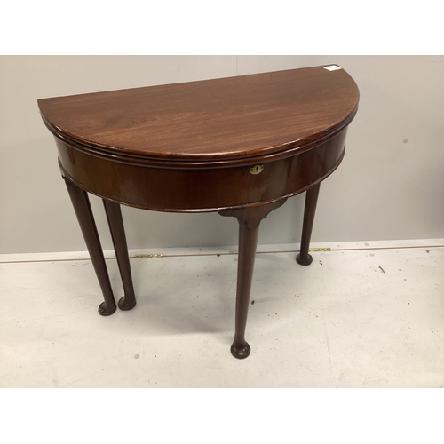 1033 - A George III walnut D shaped folding tea table, width 82cm, depth 41cm, height 73cm