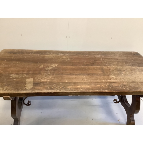 1037 - A Spanish style beech rectangular dining table, on shaped supports with iron stretcher, length 180cm... 