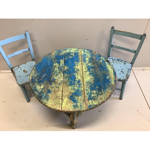 1064 - A circular painted pine low table, diameter 75cm together with two painted child's chairs