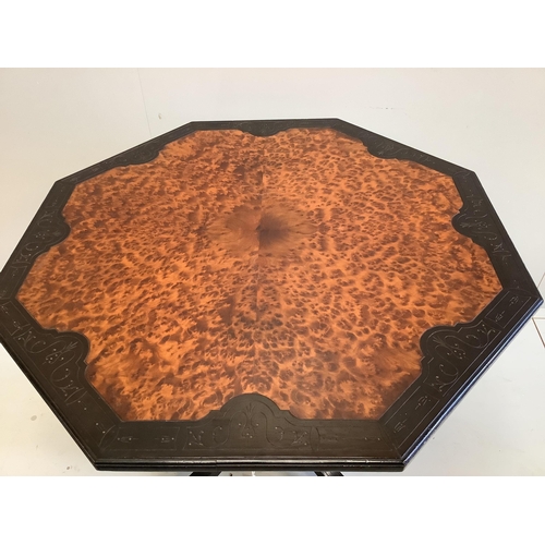 1065 - A late Victorian ebonised and amboyna octagonal centre table, width 89cm, height 71cm