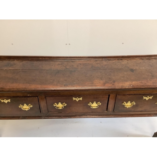 1088 - An 18th century oak low dresser, fitted with three drawers, raised on turned legs, length 184cm, dep... 