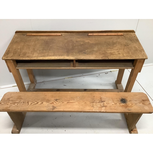 1095 - An early 20th century oak and pine child's desk with integral seat, width 120cm, depth 70cm, height ... 