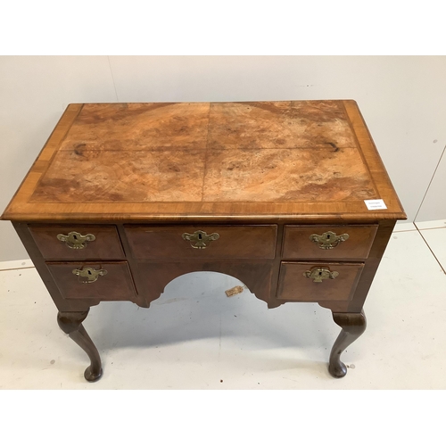 1101 - A Queen Anne revival feather banded walnut kneehole dressing table (front leg a/f), width 88cm, dept... 