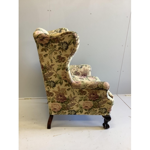 1103 - An early 20th century upholstered wing armchair on claw and ball feet, width 80cm, depth 76cm, heigh... 