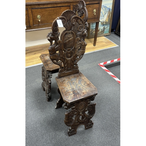 1153 - A pair of 18th century style carved walnut hall chairs, width 36cm, depth 27cm, height 106cm