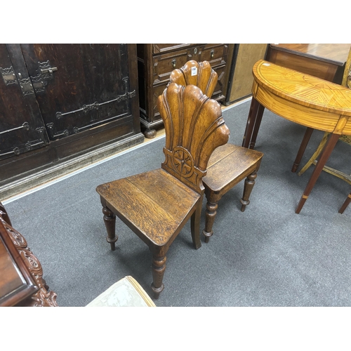 1163 - A pair of Victorian carved oak hall chairs, width 40cm, depth 40cm, height 87cm